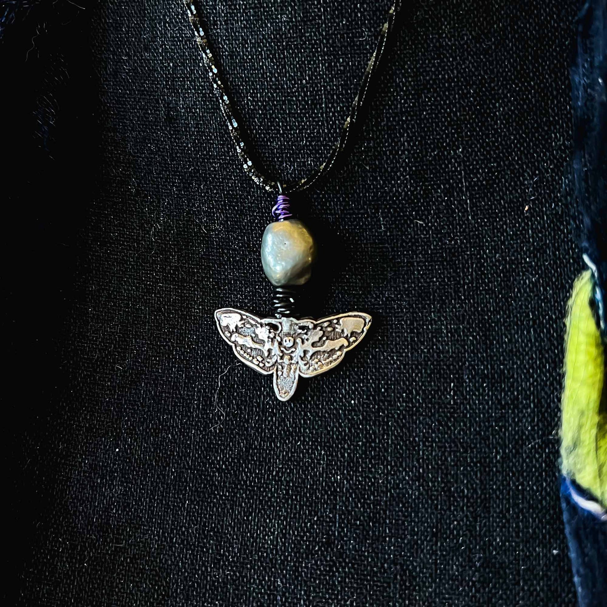 View from right; White Copper; Gothic Deaths Head Moth Necklace Black Purple Accents